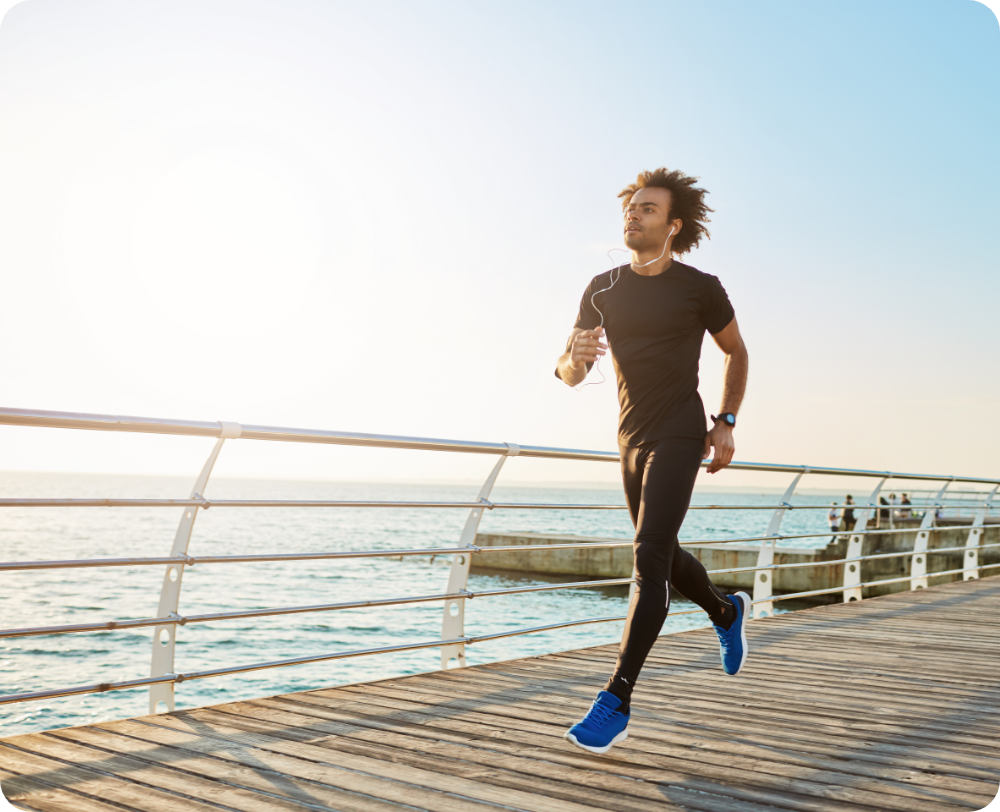 attractive-male-athlete-wearing-stylish-black-sport-clothing-blue-sneakers-figure-man-athlete-doing-cardio-running-exercises-sunny-summer-morning